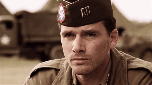 A Man In A Military Uniform Has A Hat With The Letters Tn On It GIF