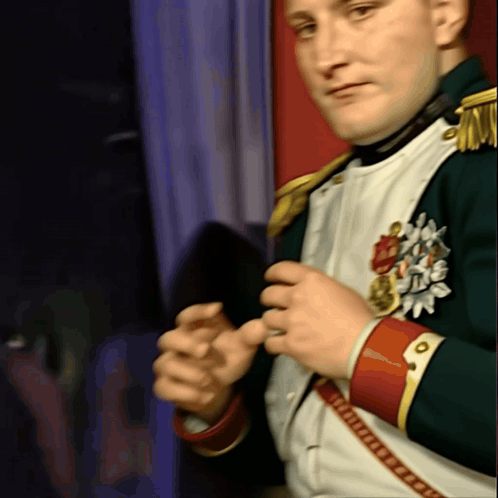 A Man In A Military Uniform Has A Medal On His Chest That Says ' Napoleon ' GIF