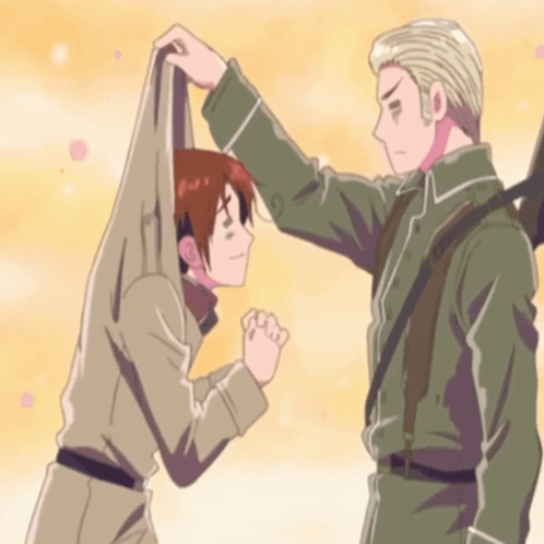A Man In A Military Uniform Holds Another Man 'S Arm GIF
