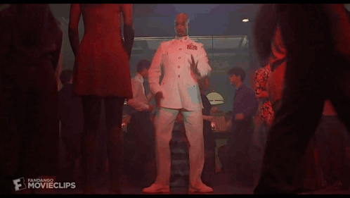 A Man In A Military Uniform Is Dancing In A Club GIF
