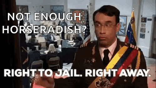 A Man In A Military Uniform Is Giving A Speech In Front Of A Group Of People . GIF