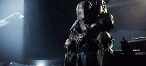 A Man In A Military Uniform Is Holding A Gun And Talking On A Radio GIF