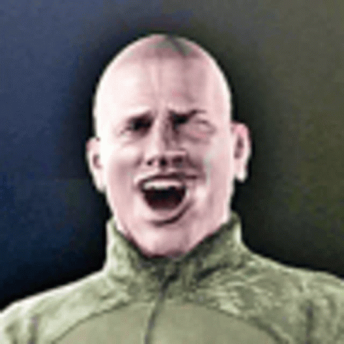 A Man In A Military Uniform Is Making A Funny Face . GIF