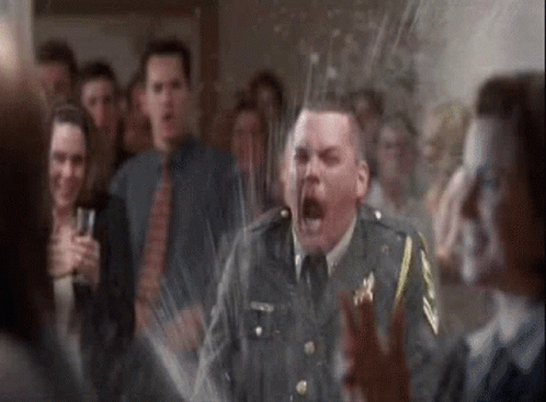 A Man In A Military Uniform Is Screaming In Front Of A Crowd Of People At A Party . GIF