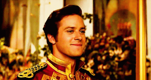 A Man In A Military Uniform Is Smiling In Front Of A Painting . GIF