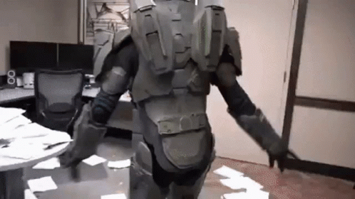 A Man In A Military Uniform Is Standing In A Room With A Lot Of Papers On The Floor . GIF