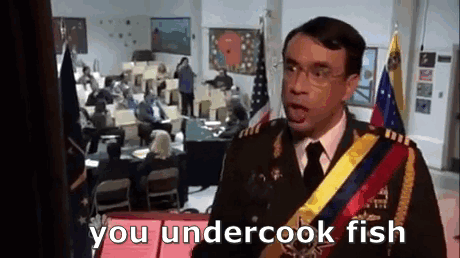 A Man In A Military Uniform Is Standing In Front Of A Crowd Of People And Talking To Them . GIF