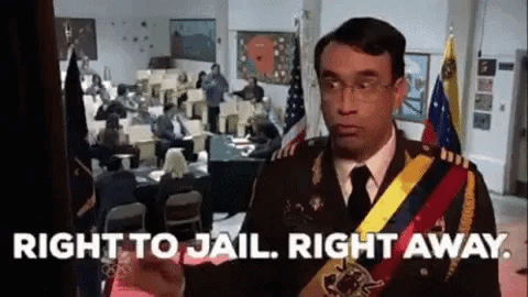 a man in a military uniform is standing in front of a room with people sitting at desks .
