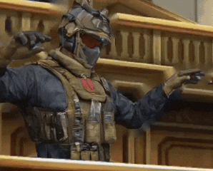A Man In A Military Uniform Is Standing On A Balcony GIF