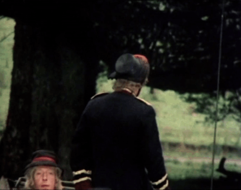 A Man In A Military Uniform Is Talking To Another Man In A Car GIF