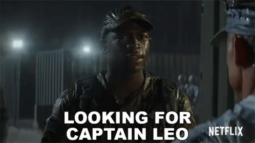 A Man In A Military Uniform Is Talking To Another Man In A Dark Room And Says `` Looking For Captain Leo '' . GIF