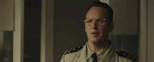 A Man In A Military Uniform Is Wearing Glasses GIF