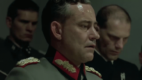 a man in a military uniform says " my führer " in front of a group of men