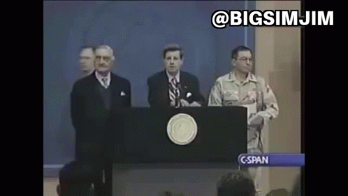 A Man In A Military Uniform Stands Behind A Podium Giving A Speech To A Crowd . GIF