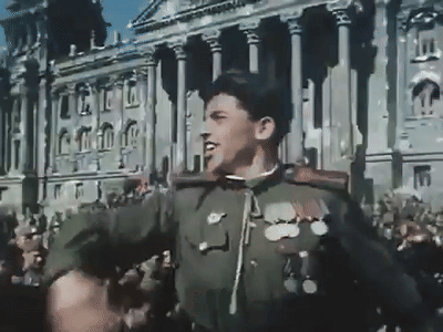 A Man In A Military Uniform Stands In Front Of A Crowd GIF