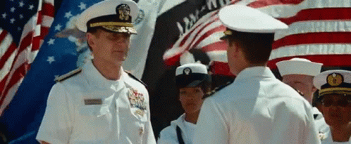 A Man In A Military Uniform Stands In Front Of A Flag That Says Liberty GIF