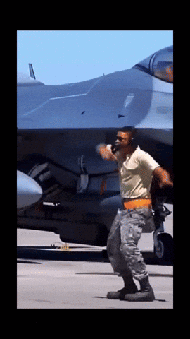 Man In Military Uniform In Front Of Jet GIF