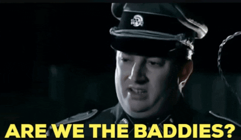 A Man In A Military Uniform With The Words Are We The Baddies On The Bottom GIF