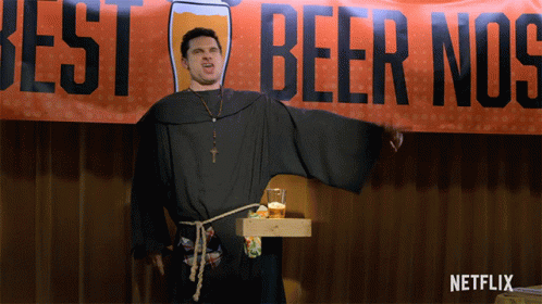 Man In Monk Costume In Front Of Best Beer Nos Banner GIF