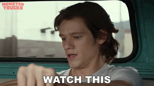 a man in a monster trucks truck says " watch this "