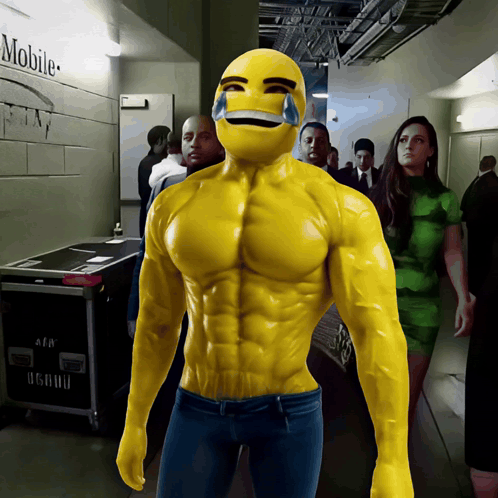 A Man In A Muscle Suit Is Standing In A Hallway With A Mobile Sign On The Wall Behind Him GIF
