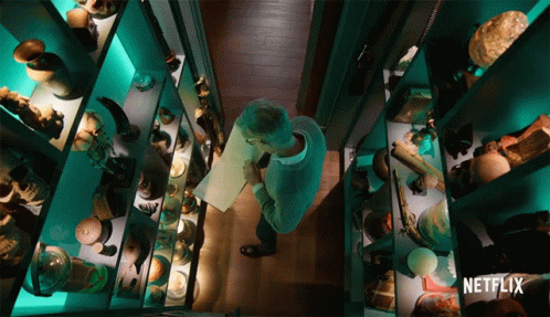 A Man In A Museum With A Netflix Logo On The Bottom Right GIF