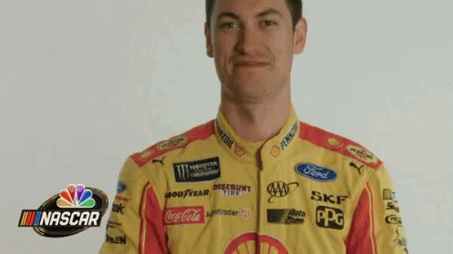A Man In A Nascar Uniform Is Holding A Beach Ball In Front Of His Head GIF