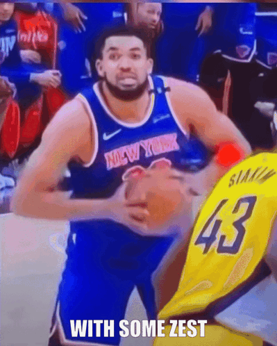 A Man In A New York Jersey Is Holding A Basketball In His Hands GIF