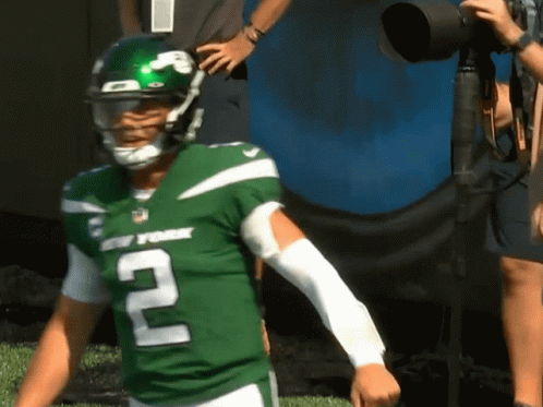 A Man In A New York Jets Uniform Stands On A Field GIF