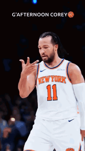 A Man In A New York Knicks Jersey Is Giving A Thumbs Up . GIF