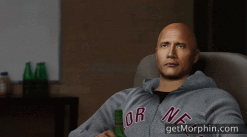 a man in a new york sweatshirt holds a beer bottle