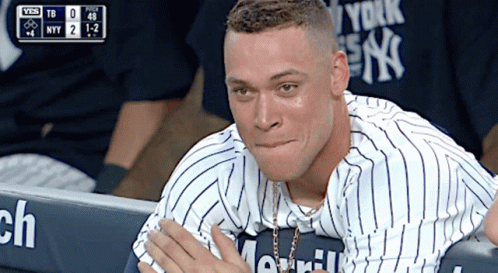 A Man In A New York Yankees Jersey Sits In The Dugout During A Game GIF