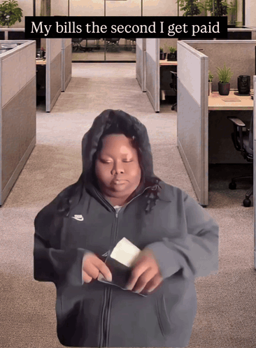 a man in a nike hoodie is taking money out of his wallet with the caption " my bills the second i get paid "