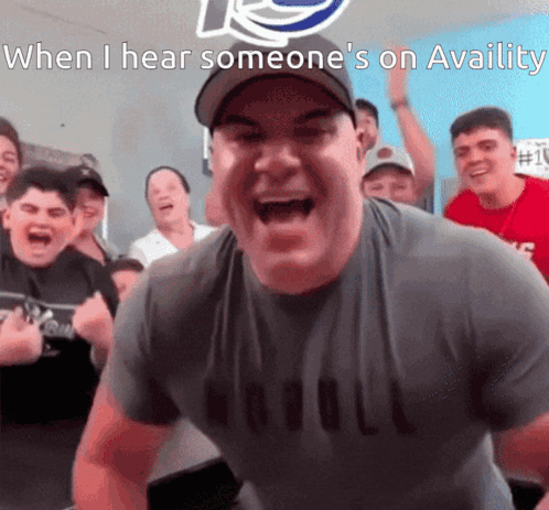 A Man In A Nobull Shirt Is Screaming In Front Of A Crowd Of People GIF