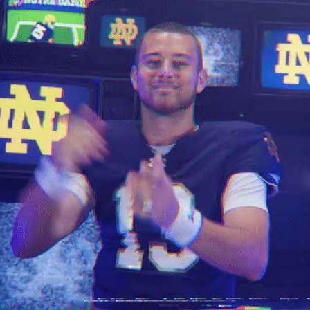 a man in a notre dame jersey is clapping