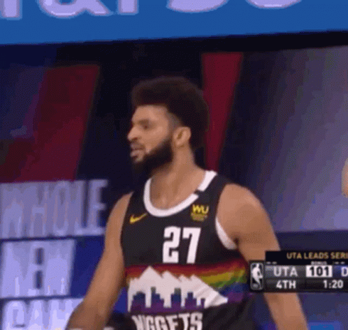 A Man In A Nuggets Jersey Stands In Front Of A Screen GIF