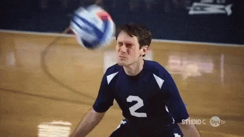 A Man In A Number 2 Jersey Is Playing Volleyball On A Court GIF