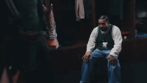 a man in a number 3 jersey sits in a locker room