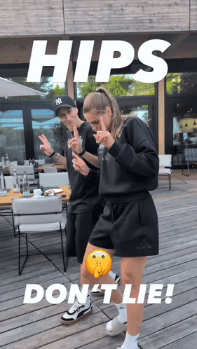 A Man In A Ny Hat Stands Next To A Woman In A Black Outfit GIF