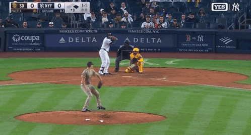 A Man In A Ny Yankees Uniform Is Walking On A Field GIF