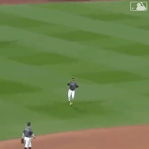 A Man In A Nyc Jersey Is Dancing On The Field . GIF