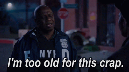 A Man In A Nypd Jacket Talks To Another Man GIF