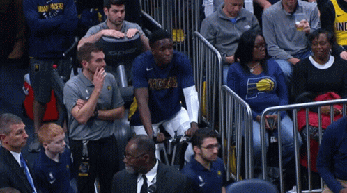 A Man In A Pacers Shirt Sits In The Stands Watching A Game GIF
