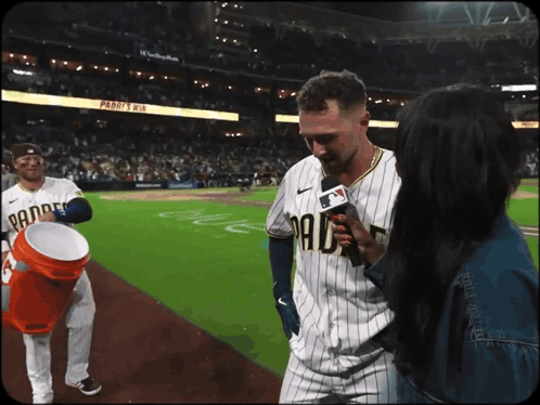 a man in a padres uniform is being interviewed