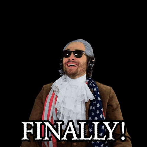 A Man In A Patriotic Costume Has His Arms In The Air And The Word Finally Is Behind Him GIF