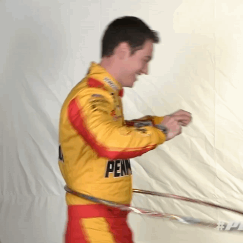 A Man In A Pennsylvania Racing Suit Hula Hoops GIF
