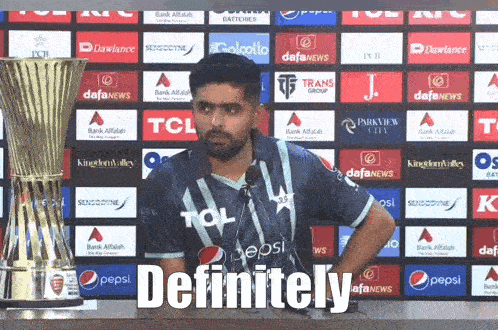 A Man In A Pepsi Shirt Stands In Front Of A Trophy And Says Definitely GIF