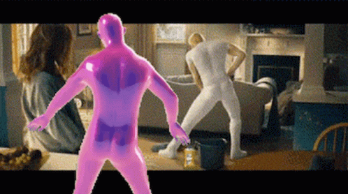 a man in a pink bodysuit is dancing in a living room with other people