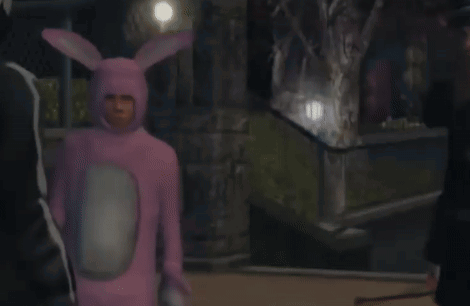 A Man In A Pink Bunny Costume Is Standing Next To A Man In A Black Suit GIF