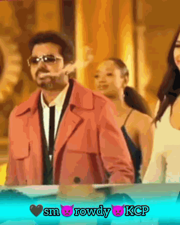 A Man In A Pink Coat Is Smoking A Cigarette In Front Of Two Women GIF